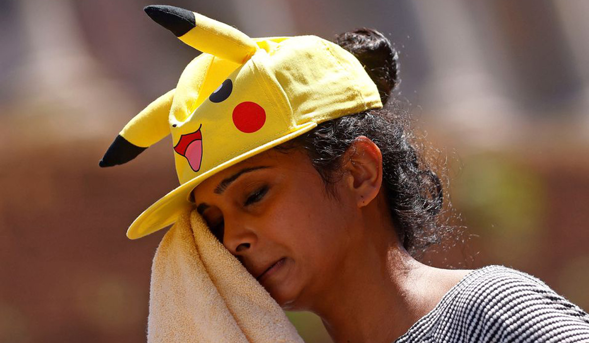 A woman wipes off sweat with a towel